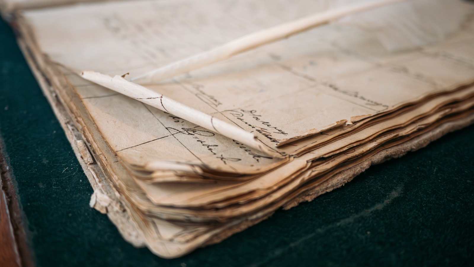 Close-up of an old, open ledger book with handwritten entries in faded ink.